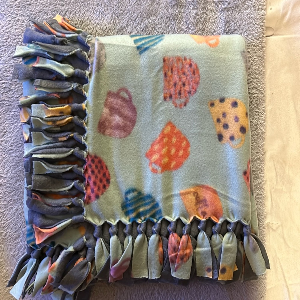 50x60” fleece tie blanket. Tea cup pattern fleece with gray fleece backing.